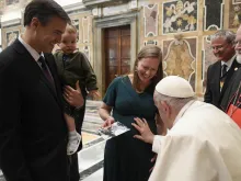 Pope Francis blesses an unborn baby during the Papal Foundation's annual pilgrimage in Rome, Friday, April 12, 2024.