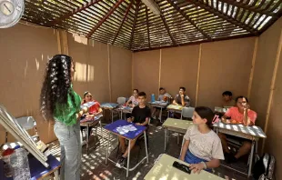 Some young people from Gaza during study aid activities in a gazebo inside the compound of the Latin Parish of the Holy Family. Beginning June 10, 2024, about 150 children and teenagers ages 4 to 17 who are sheltering in the Latin parish and in the Orthodox parish have taken up their books and notebooks again to reconnect with their studies. Three gazebos in the garden host study groups. They were open-sided, but they have been closed to help the youth avoid distractions, as there are always people around. Credit: Photo courtesy of Father Gabriel Romanelli