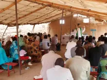 A priest celebrates Mass in Sudan before the outset of war.