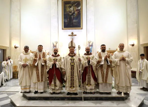 Group photo of the newly ordained priests, George and Johnny Jallouf, to the left and right of Bishop Hanna Jallouf, their uncle, the Latin apostolic vicar of Aleppo. On the far left is the vicar of the Custody of the Holy Land, Ibrahim Faltas. On the far right is the parish priest of St. Francis Parish in Aleppo, Bahjat Karakach. The ordination took place at the Franciscan parish in Aleppo on July 6, 2024, and is the first in 17 years. Credit: Photo courtesy of the Tawk Center