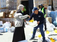 Catholic Relief Services workers help to distribute humanitarian aid materials to Gazan civilians in March 2024.