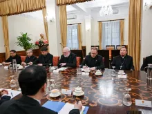 Vatican Secretary for Relations with States Archbishop Paul Gallagher (center) meets with Vietnamc’s Foreign Minister Bui Thanh Son (unseen) and other officials at the Foreign Ministry in Hanoi on April 9, 2024.