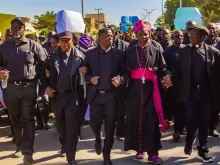 Catholic Archbishop Matthew Ishaya Audu of Jos marches alongside evangelical leader Rev. Dr. Gideon Para-Mallam in front of the Plateau state governor's office building in Jos, Nigeria, Jan. 8, 2024.