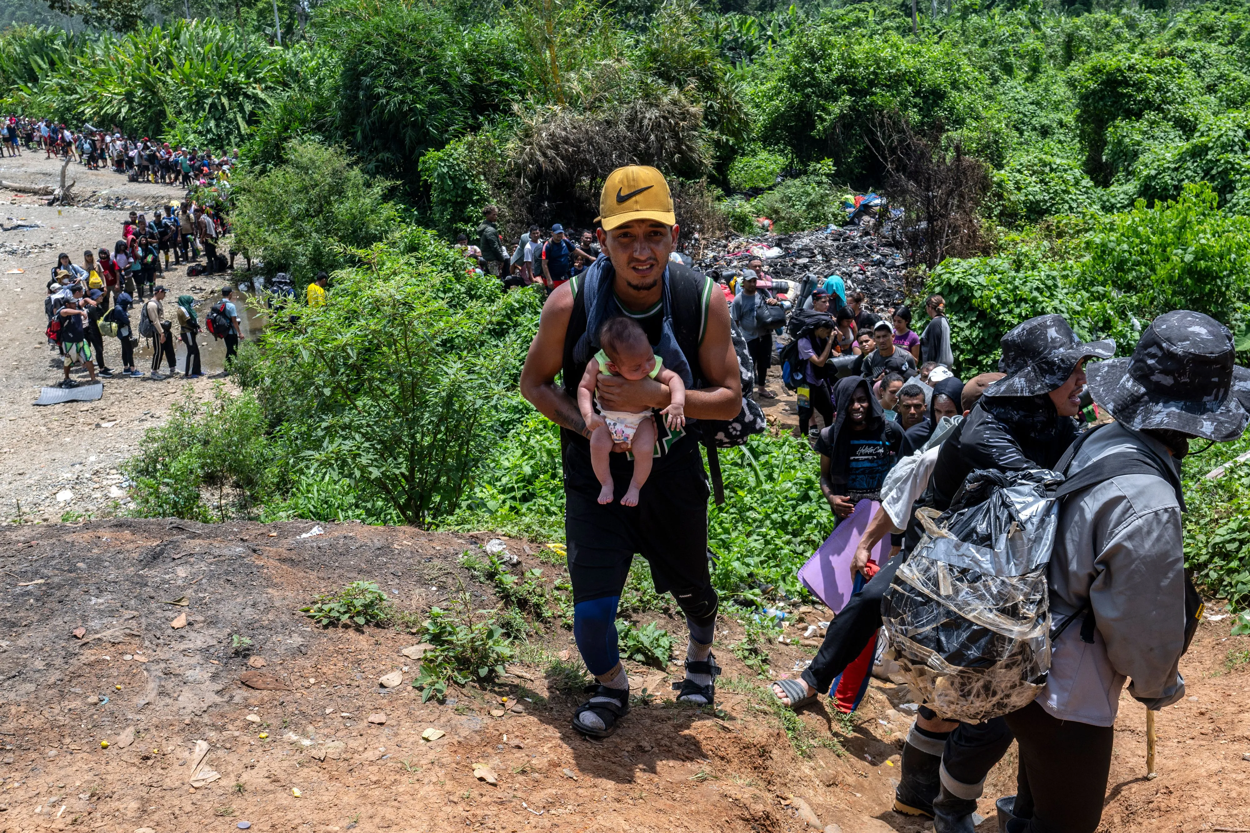 A U.S.-bound migrant carries a baby in the Darien Province in Panama, on Sept. 22, 2023.?w=200&h=150