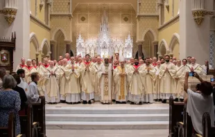 Bishop Jacques Fabre-Jeune poses alongside many of the priests of the Diocese of Charleston at a recent ordination. The diocese has seen a recent surge in vocations. Credit: The Catholic Miscellany/Doug Deas