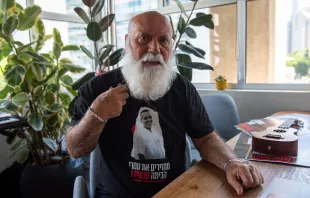 Danny Miran shows the T-shirt with a photo of his son Omri, one of the Israelis kidnapped on Oct. 7, 2023, and who is still being held hostage in Gaza. On the T-shirt, the Hebrew inscription reads: “Bring them home now!”, the motto of the campaign to bring back the hostages. A few days after Oct. 7, Danny Miran, 79, left his home in northern Israel and joined the Hostages and Missing Families Forum in Tel Aviv. His life’s purpose has become bringing his son back home. Credit: Marinella Bandini