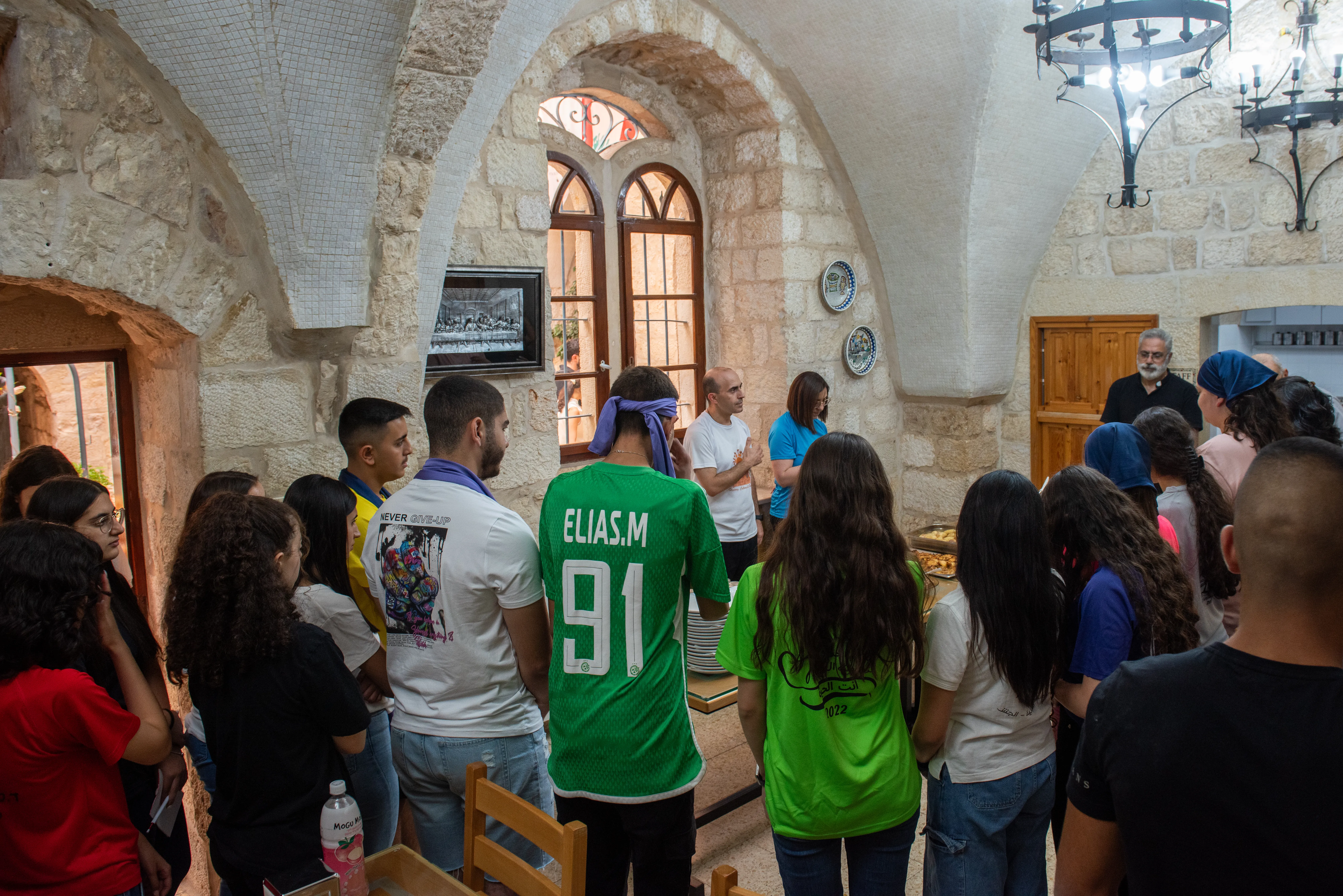 A group of young people from the Apostolic Movement of Jish, led by Father Sandy Habib, during prayer before the meal on July 12, 2024, at the Maronite convent in Jerusalem. The aim is “bringing ourselves closer to Jesus,” Habib explained to CNA. “We try to achieve this through spiritual activities, social activities like trips, and by announcing Jesus Christ.”?w=200&h=150