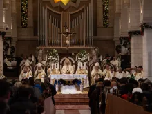 The Latin Patriarch of Jerusalem, Cardinal Pierbattista Pizzaballa, presides over the Christmas Midnight Mass in the Church of St. Catherine in Bethlehem. With him, Cardinal Konrad Krajewski, papal envoy, H. E. Adolfo Tito Yllana, Apostolic Delegate in Jerusalem and Palestine, and the bishops of the Latin Patriarchate of Jerusalem concelebrated. Dec. 25, 2023.