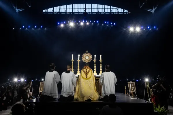 Bishop Andrew Cozzens of Crookston, Minnesota, who spearheaded the U.S. bishops’ initiative of Eucharistic Revival, adores Christ in the Eucharist with tens of thousands of people in Lucas Oil Stadium. Credit: Jeffrey Bruno