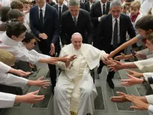 Pope Francis greets altar servers from France.