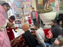 Injured parishioners receive Communion on the third Sunday of Advent, Dec. 17, 2023, at Holy Family Parish in Gaza.