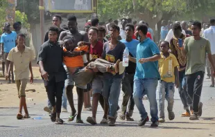 Sudanese carry a man injured during clashes as part of protests against a military coup that overthrew the transition to civilian rule, on Oct. 25, 2021 in the capital Khartoum. - Sudan's top general declared a state of emergency Monday as soldiers rounded up civilian leaders, with three people killed as soldiers put down furious protests decrying a coup. -/AFP via Getty Images