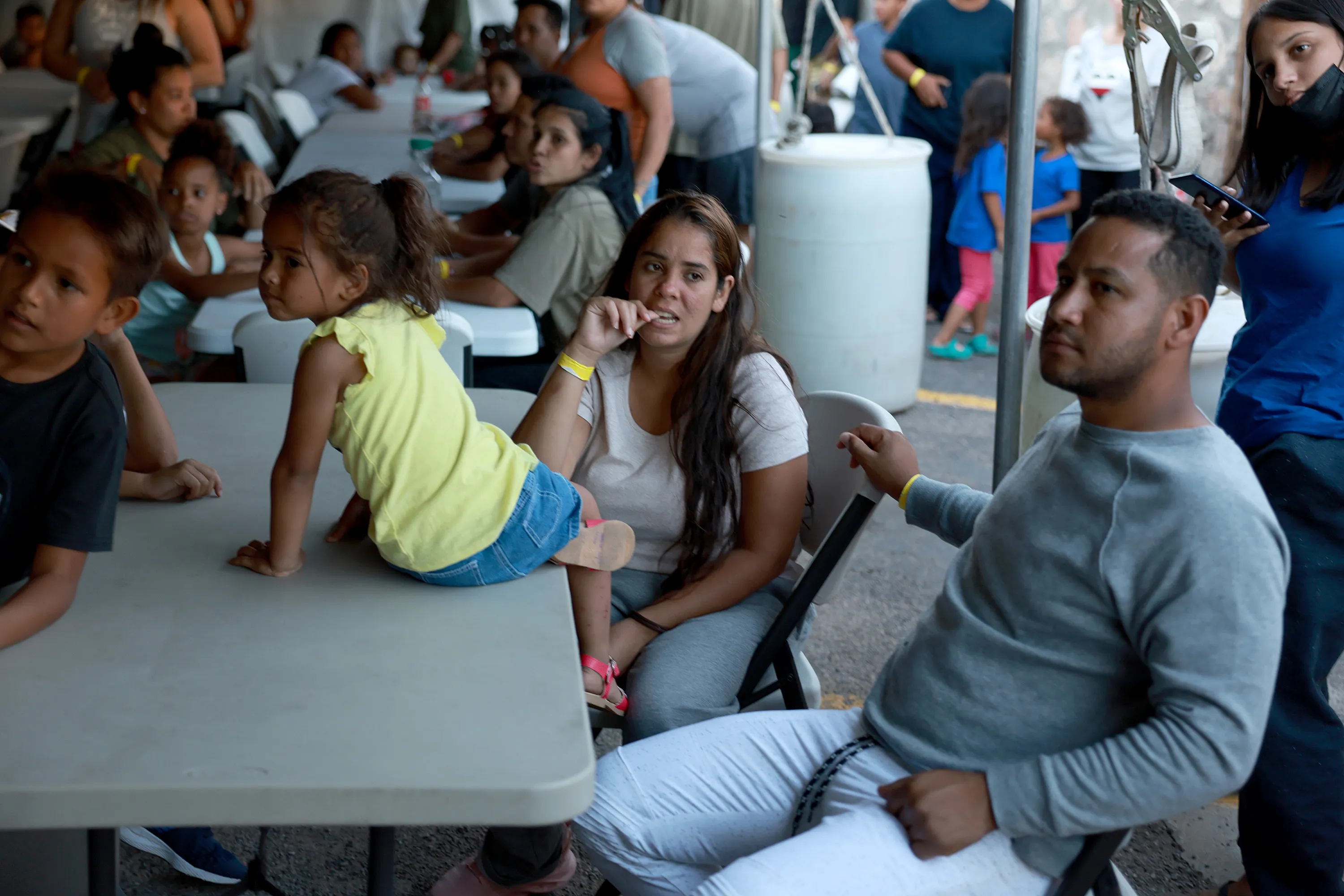 Dainelys Soto, Genesis Contreras, and Daniel Soto, who arrived from Venezuela after crossing the U.S. border from Mexico, wait for dinner at a hotel provided by the Annunciation House on September 22, 2022 in El Paso, Texas.?w=200&h=150