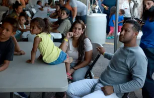 Dainelys Soto, Genesis Contreras, and Daniel Soto, who arrived from Venezuela after crossing the U.S. border from Mexico, wait for dinner at a hotel provided by the Annunciation House on September 22, 2022 in El Paso, Texas. Credit: Photo by Joe Raedle/Getty Images