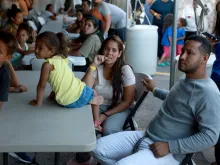 Dainelys Soto, Genesis Contreras, and Daniel Soto, who arrived from Venezuela after crossing the U.S. border from Mexico, wait for dinner at a hotel provided by the Annunciation House on September 22, 2022 in El Paso, Texas.