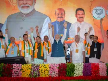 India's Prime Minister Narendra Modi waves to the his supporters during a political event organised by the Bharatiya Janata Party (BJP) at the GMIT College Grounds on March 25, 2023, in Davangere, India.