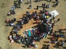 This image made from an AFPTV video taken in the Nigerian village of Maiyanga on Dec. 27, 2023, shows families burying in a mass grave their relatives killed in deadly attacks conducted by armed groups in central Plateau State. The death toll from a series of attacks on villages in central Nigeria has climbed to almost 200, local authorities said.