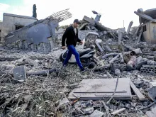 A man walks through the rubble of destroyed buildings following strikes on the the town of Naqura in southern Lebanon close to the border with northern Israel on Jan. 4, 2024. Four Hezbollah fighters were killed overnight in southern Lebanon, the Iran-backed movement announced on Jan. 4, in what Lebanese state media said were Israeli strikes on the border town of Naqura.