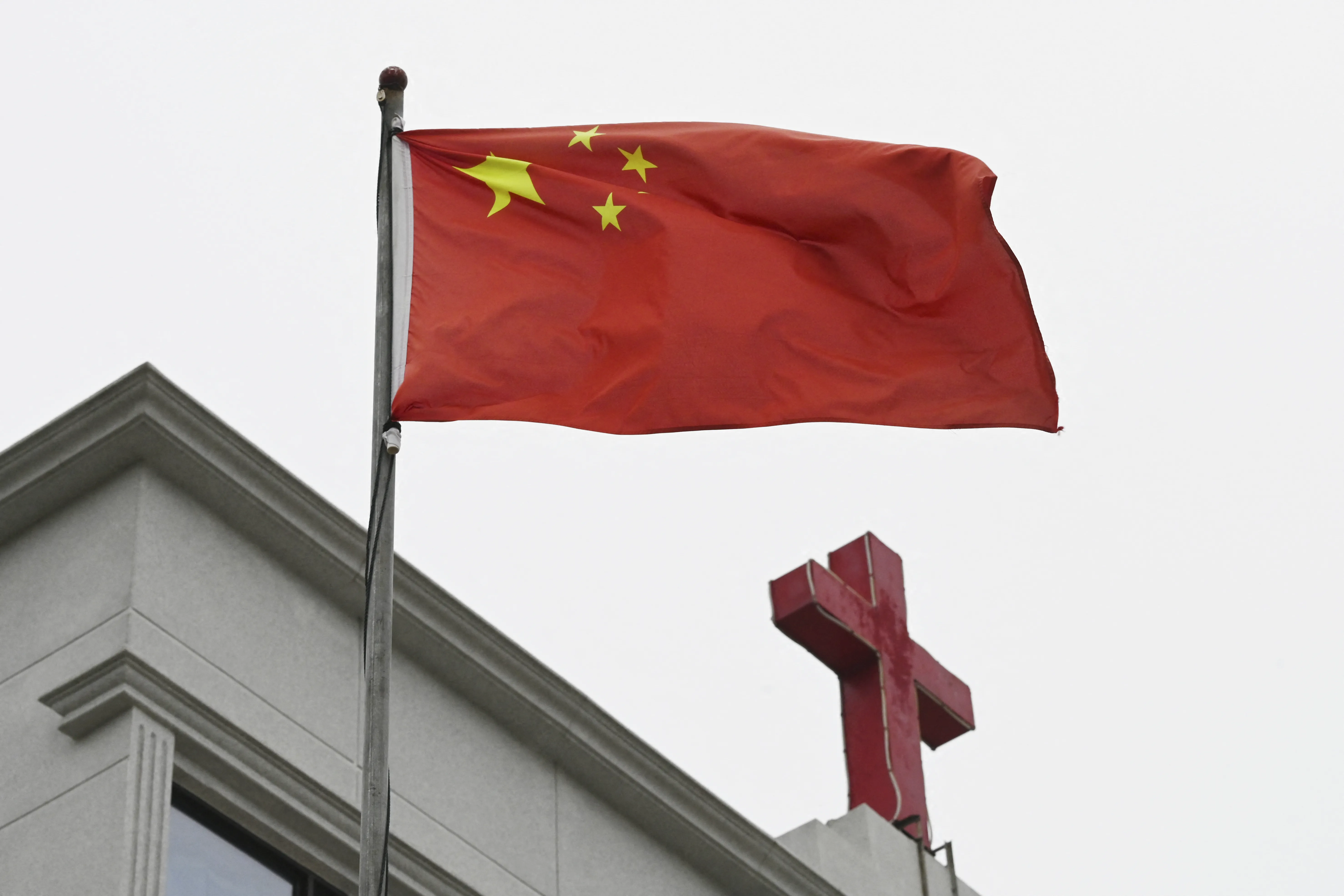 This photo taken on Jan. 15, 2024, shows a Chinese flag fluttering below a cross on a Christian church in Pingtan in China’s southeast Fujian province.?w=200&h=150