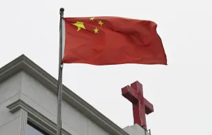 This photo taken on Jan. 15, 2024, shows a Chinese flag fluttering below a cross on a Christian church in Pingtan in China’s southeast Fujian province. Credit: GREG BAKER/AFP via Getty Images