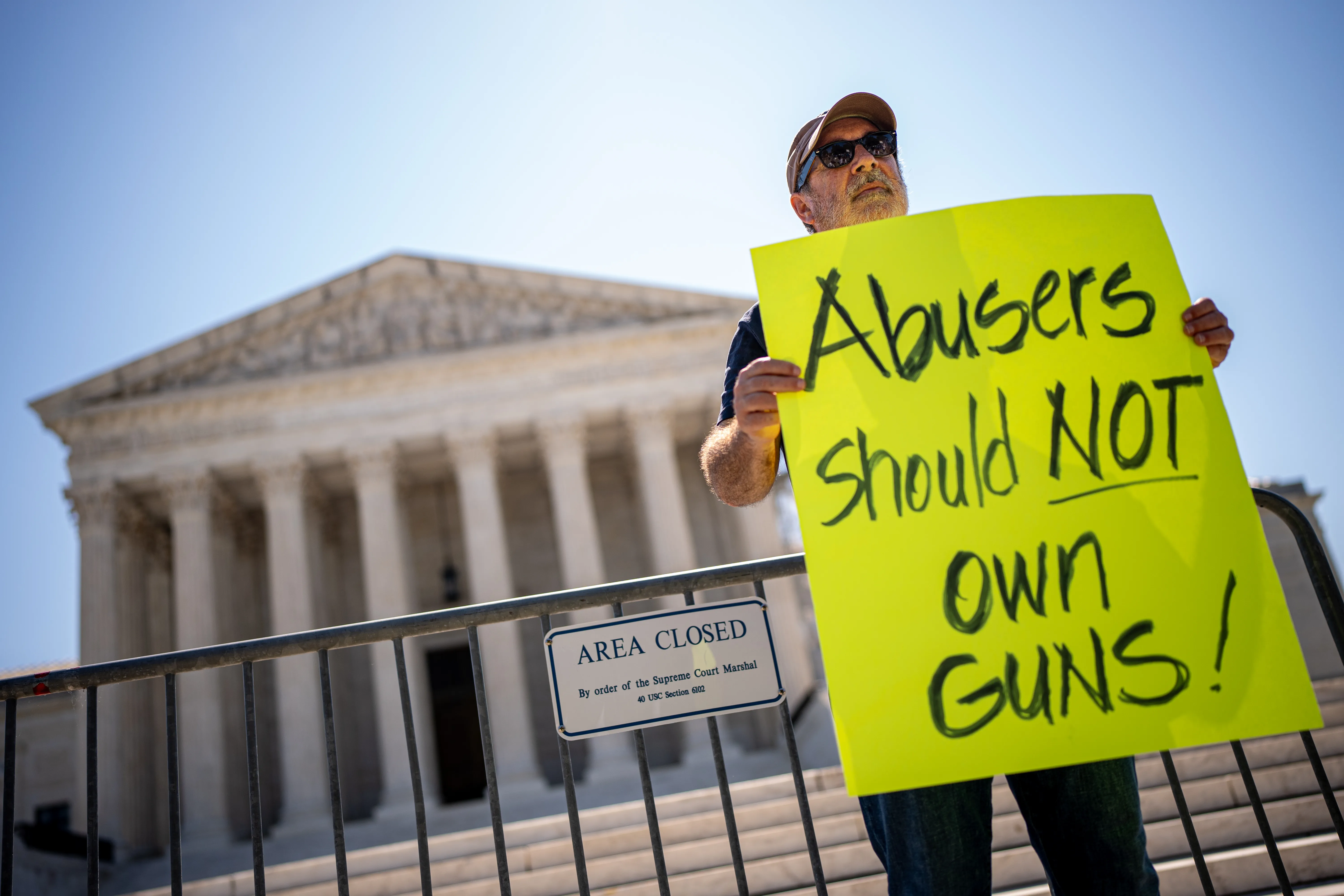 Christian Defense Coalition Director Rev. Patrick Mahoney holds a sign that reads "Abusers Should NOT Own Guns!" outside the Supreme Court on June 21, 2024, in Washington, D.C.?w=200&h=150