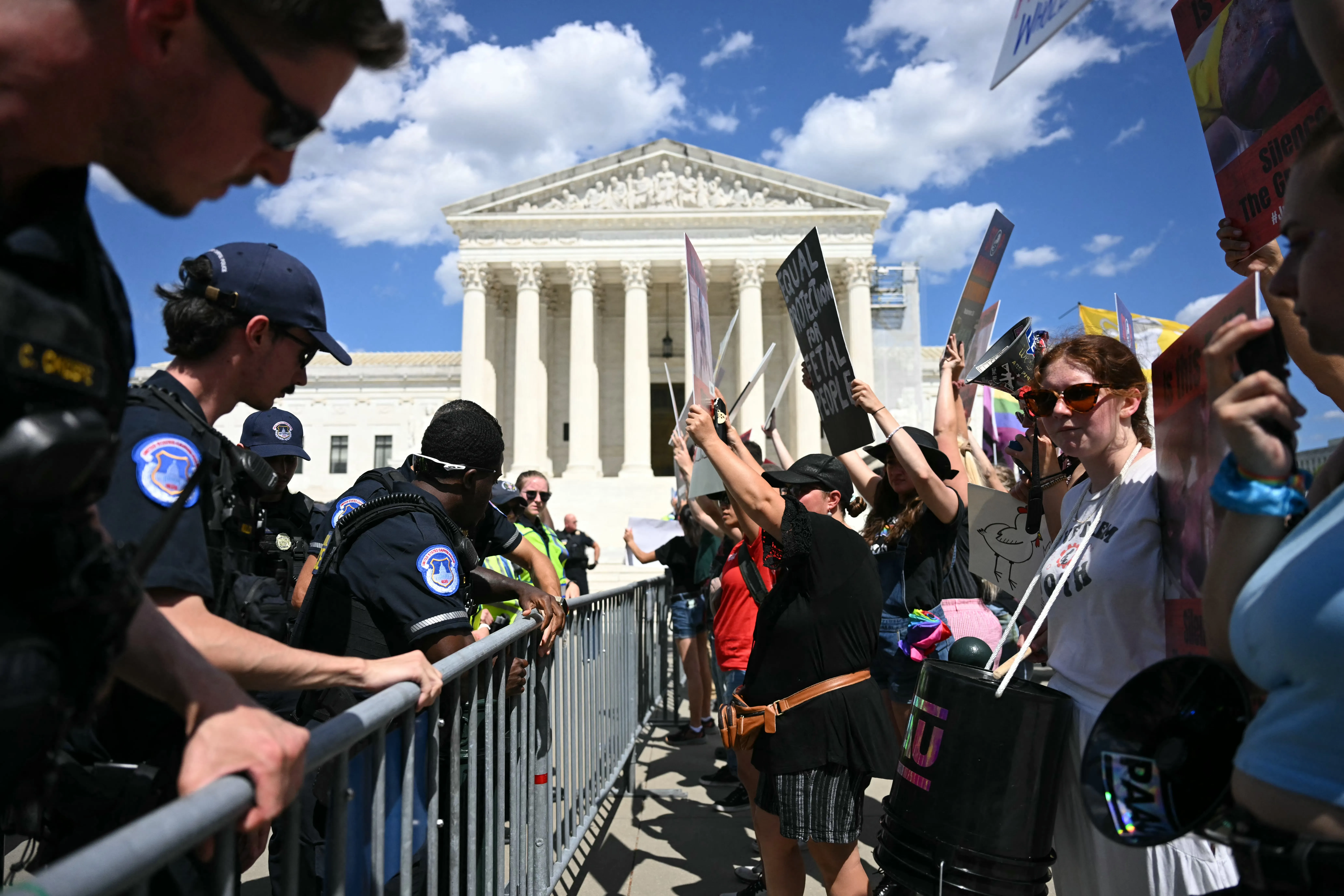 U.S. Supreme Court police officers put up barricades to separate pro-life activists (right) from abortion rights activists during a demonstration in front of the Supreme Court in Washington, D.C., on June 24, 2024.?w=200&h=150