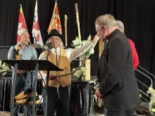 Vancouver Archbishop J. Michael Miller is presented with a gift at the Sacred Covenant signing on Sunday, March 31, 2024.