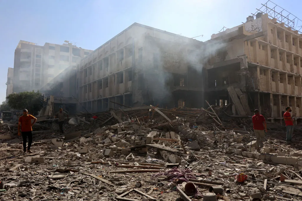 Palestinians stand on the rubble and debris of the Latin Patriarchate Holy Family School after it was hit during an alleged Israeli military bombardment in Gaza City on July 7, 2024, amid the ongoing conflict in the Palestinian territory between Israel and Hamas.?w=200&h=150