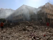 Palestinians stand on the rubble and debris of the Latin Patriarchate Holy Family School after it was hit during an alleged Israeli military bombardment in Gaza City on July 7, 2024, amid the ongoing conflict in the Palestinian territory between Israel and Hamas.