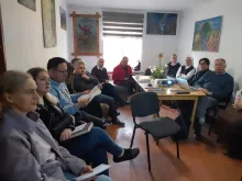 The Apostolic Administration in Bishkek, Kyrgyzstan, made up of priests, religious, and laypeople, gather in Bishkek, Kyrgyzstan, during Easter Week, April 2-3, 2024, to pray and discuss the work of the small but growing  Catholic community spread throughout the Central Asian country. Father Anthony Corcoran (pictured in glasses holding a blue pen and paper) and Caritas representative Sher Abdugapirov (glasses and light blue hoodie) can be seen in this photo.