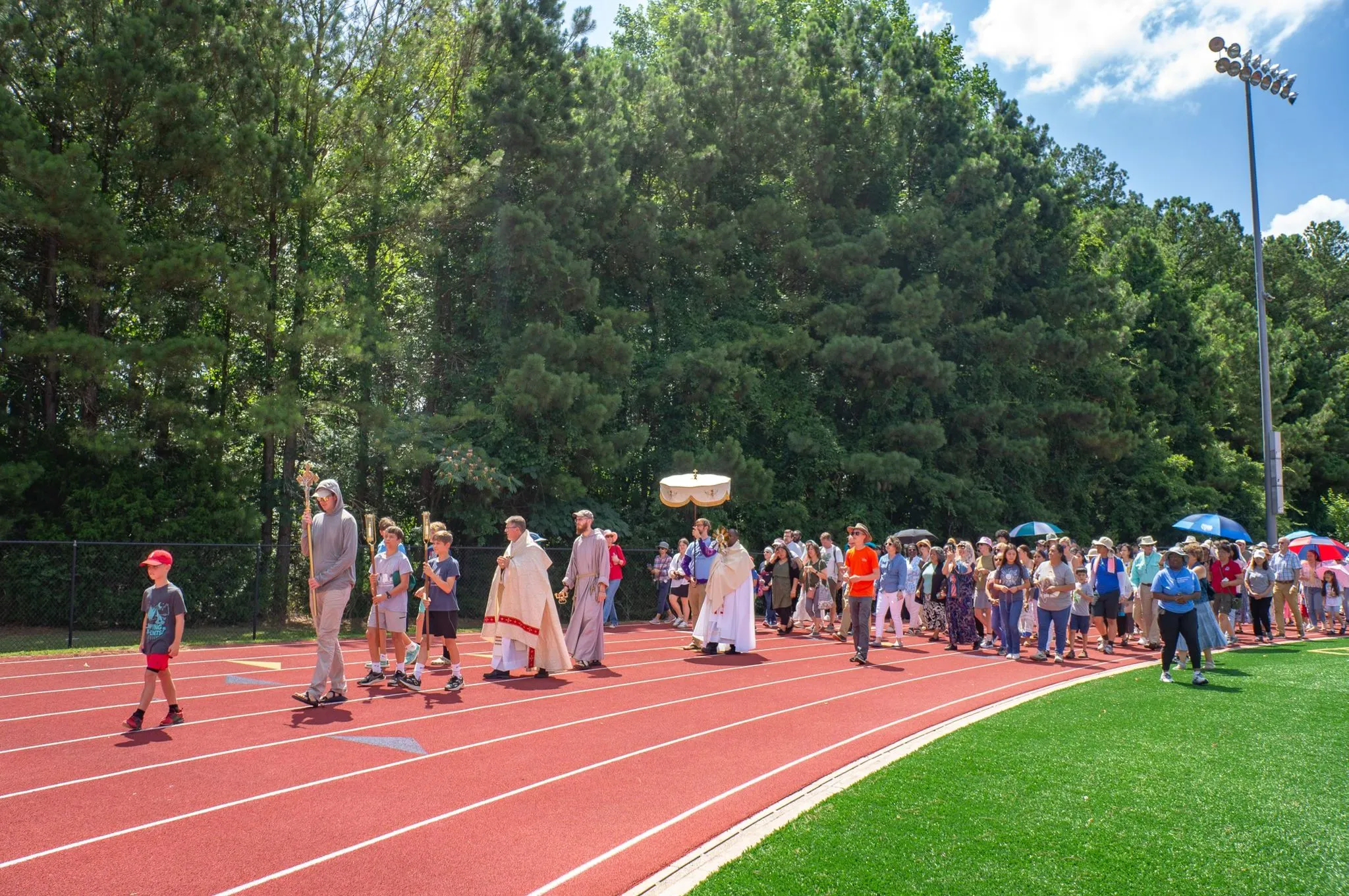 Pilgrims on the Juan Diego route of the National Eucharistic Pilgrimage process on a track in Georgia.?w=200&h=150