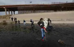 A group of migrants from South America crosses the Rio Bravo border between Mexico and the United States to request asylum. Credit: David Peinado Romero/Shutterstock