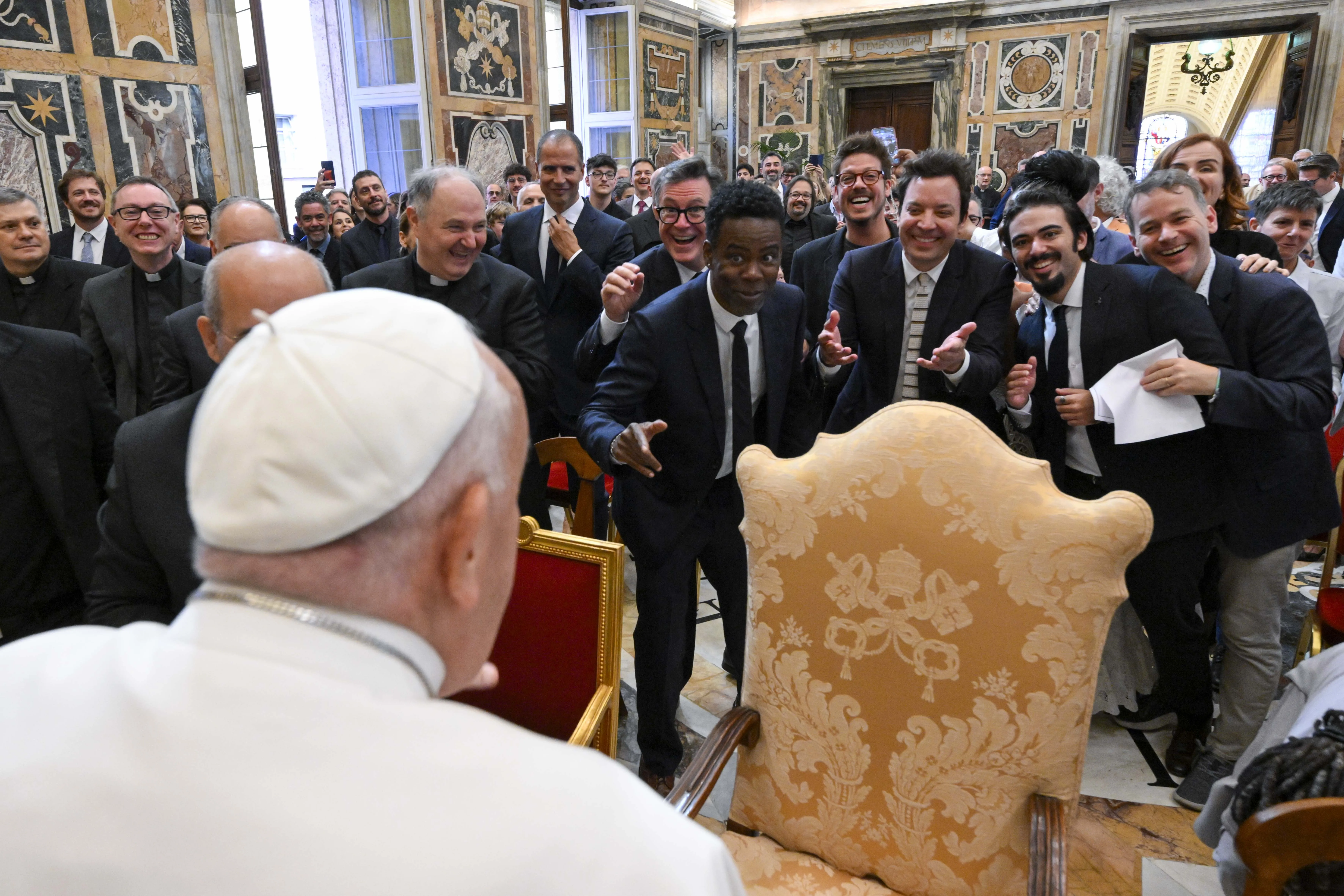 A group of comedians and humorists, including Chris Rock and Jimmy Fallon (center), share a lighthearted exchange with Pope Francis during a gathering with the pope in the Apostolic Palace at the Vatican on June 14, 2024.?w=200&h=150