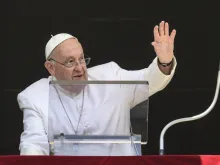 Pope Francis waves to crowds before his noon Angelus address during a hot day in Rome on July 14, 2024.