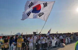 Pilgrims from South Korea wave a flag at the closing Mass of World Youth Day Lisbon with Pope Francis on Aug. 6, 2023. Credit: Hannah Brockhaus/CNA