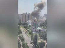 Smoke billows into the air behind a Ukrainian Greek Orthodox Church in Kyiv, Ukraine, after a missile attack on July 8, 2024.