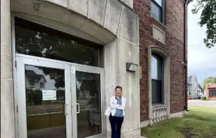 Cheryl Sporie, chair of the board of trustees at St. Thomas Aquinas Academy in Marinette, Wisconsin, stands in front of the vacant Garfield Elementary school building in the Marinette School District. Sporie filed a claim against the district on June 25, 2024, urging the district to sell the property after it refused to sell it to the Catholic school. Credit: Photo courtesy of Wisconsin Institute for Law & Liberty