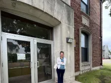 Cheryl Sporie, chair of the board of trustees at St. Thomas Aquinas Academy in Marinette, Wisconsin, stands in front of the vacant Garfield Elementary school building in the Marinette School District. Sporie filed a claim against the district on June 25, 2024, urging the district to sell the property after it refused to sell it to the Catholic school.